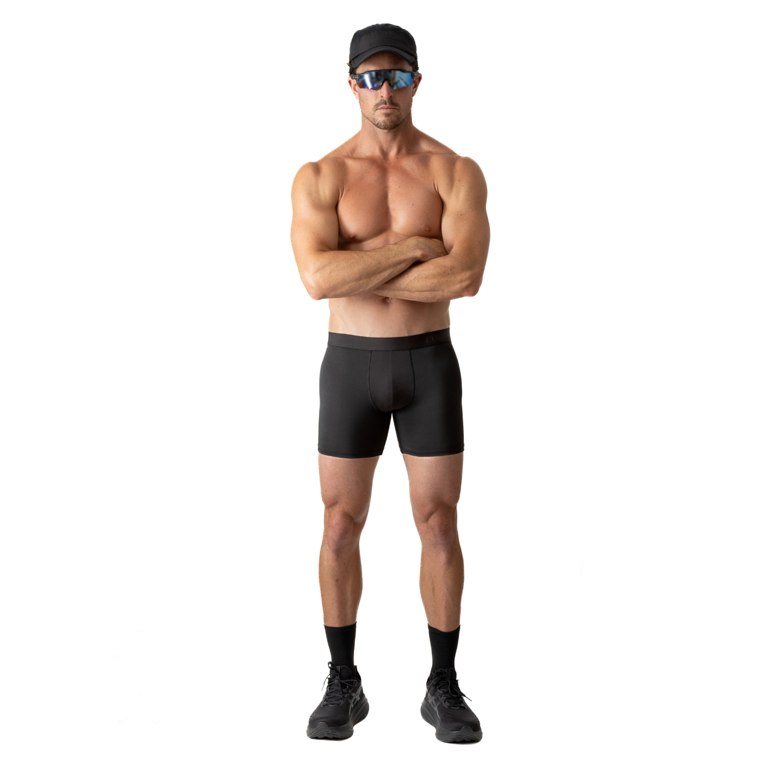 Front view of a person wearing ruhn performance underwear in Activated Black with arms crossed against a white background