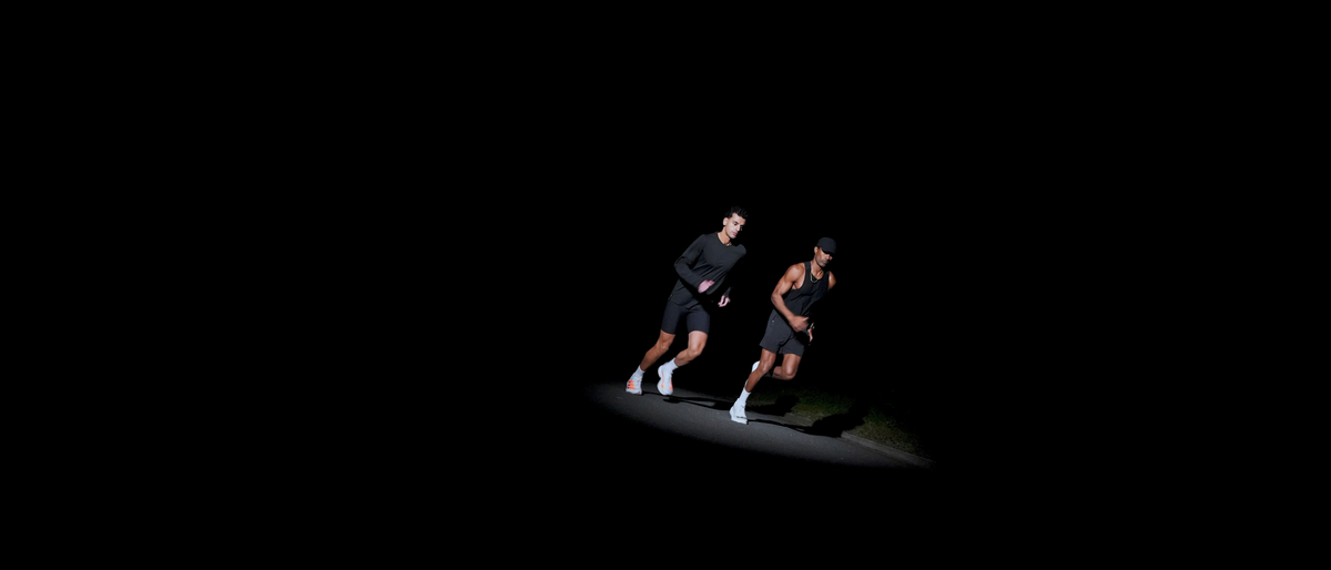 Two athletes running at night wearing ruhn performance underwear